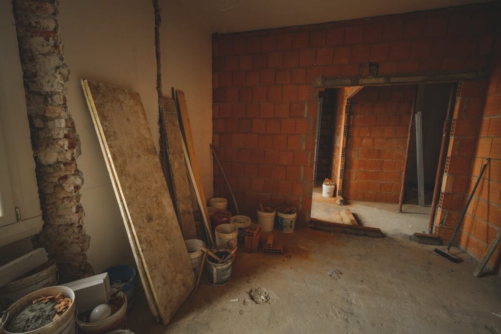Mastering the First Impression: Your intriguing post title goes here A red brick wall under construction with tools and materials scattered around in a renovation project.